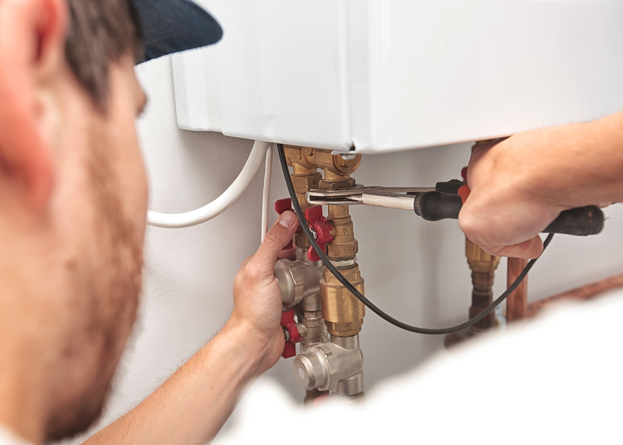 a plumber working on a water heater